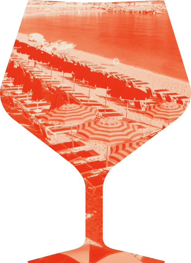 An orange mixed drink glass with a beach shown on it